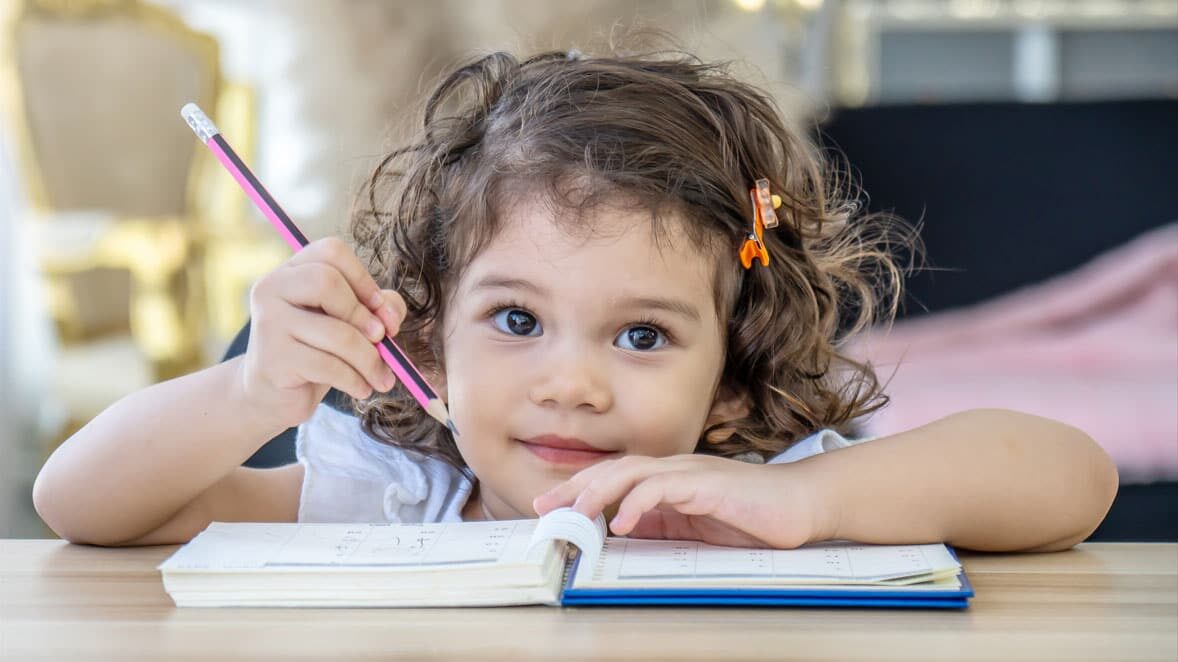 Girl with book and pencil