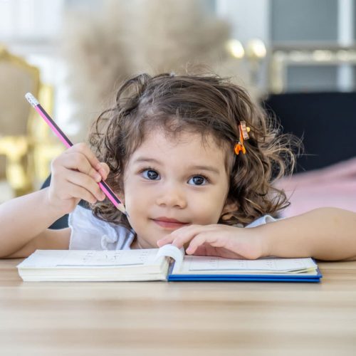 Girl with book and pencil